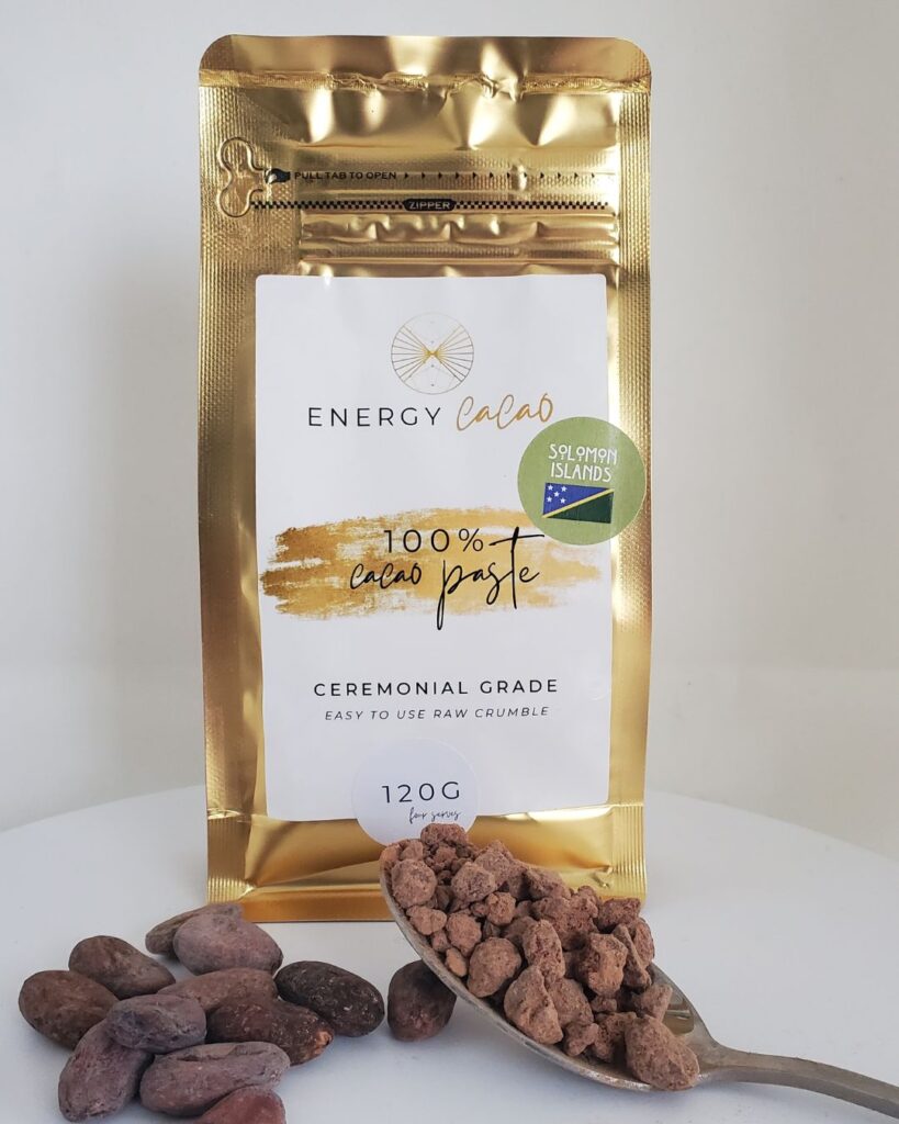 Cup of brewed cacao beside an Energy Cacao pouch